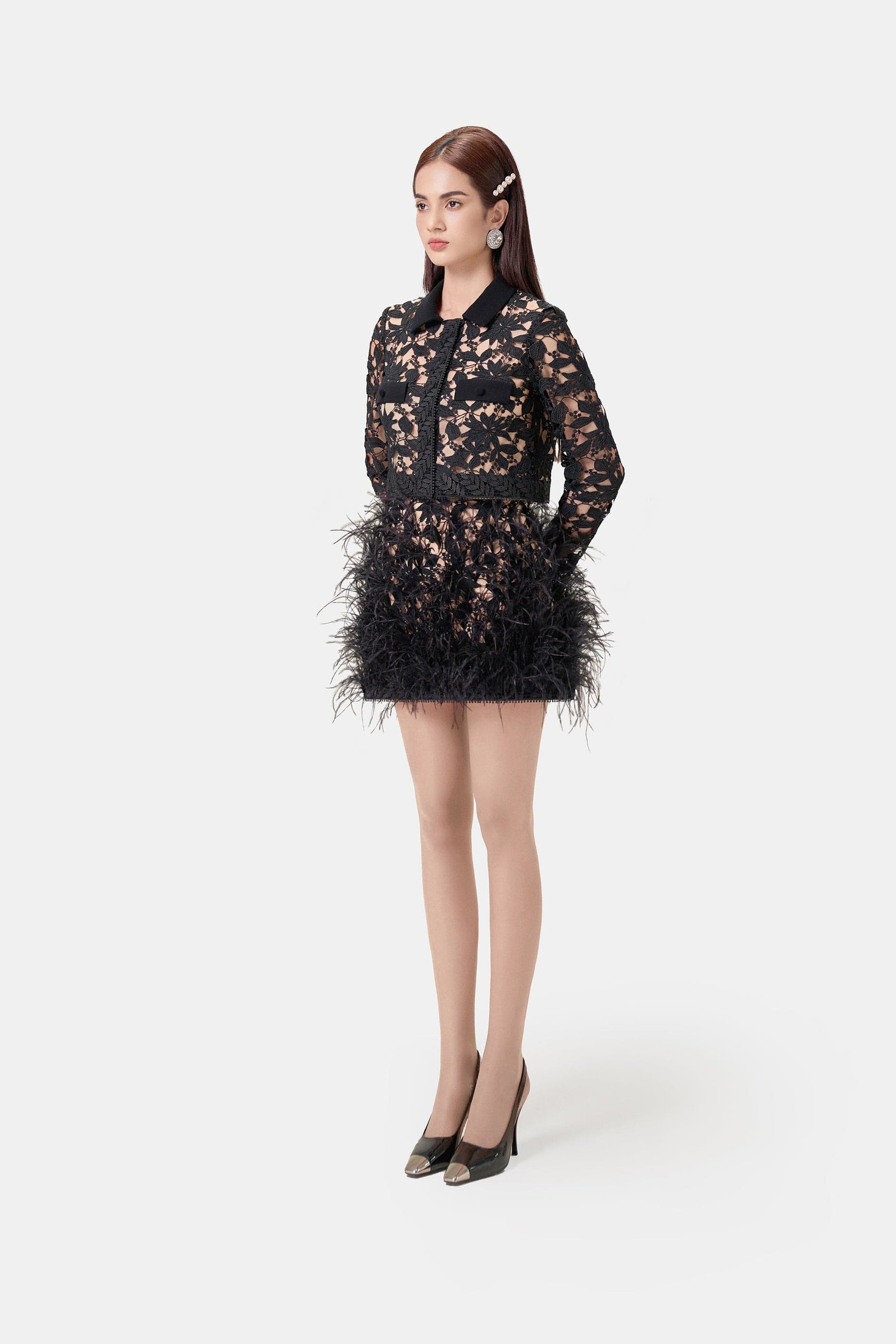 Woman in black lace feather dress and heels