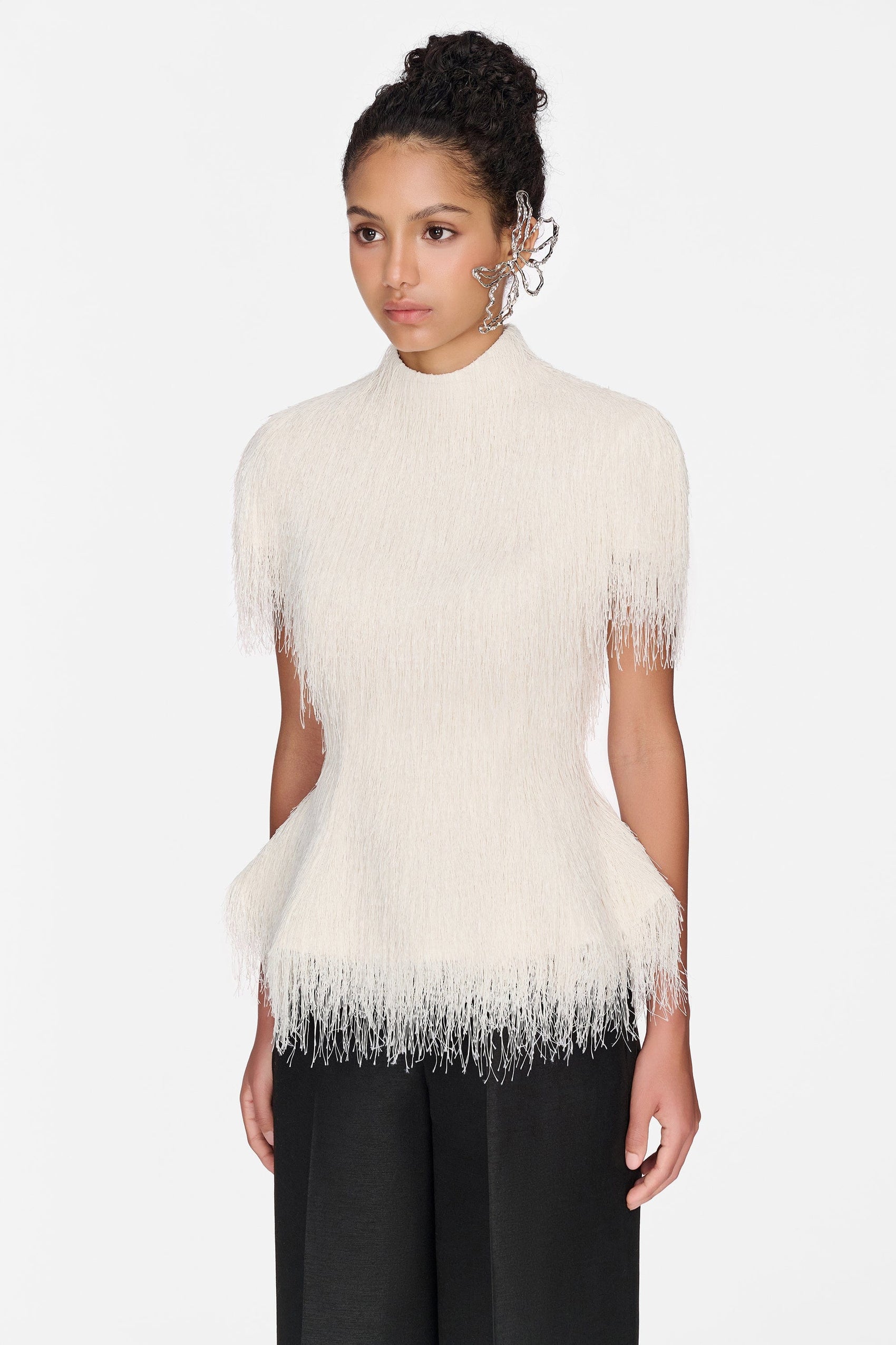 Cream fringe top on model