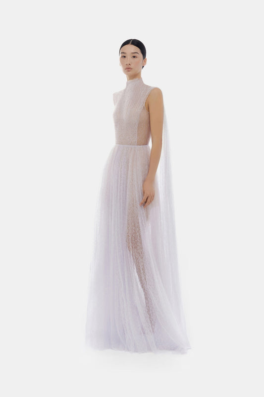 Woman in white gown with cape